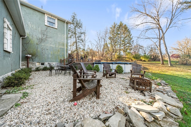 view of patio with a fire pit and a covered pool