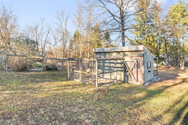 view of outbuilding with a yard