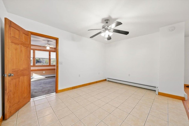 empty room featuring ceiling fan, baseboard heating, and light tile patterned flooring