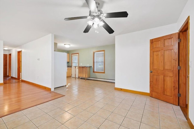 unfurnished room featuring light tile patterned floors, ceiling fan, and a baseboard heating unit