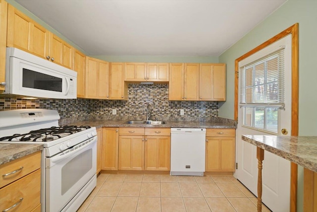 kitchen featuring white appliances, backsplash, sink, light tile patterned floors, and light brown cabinetry