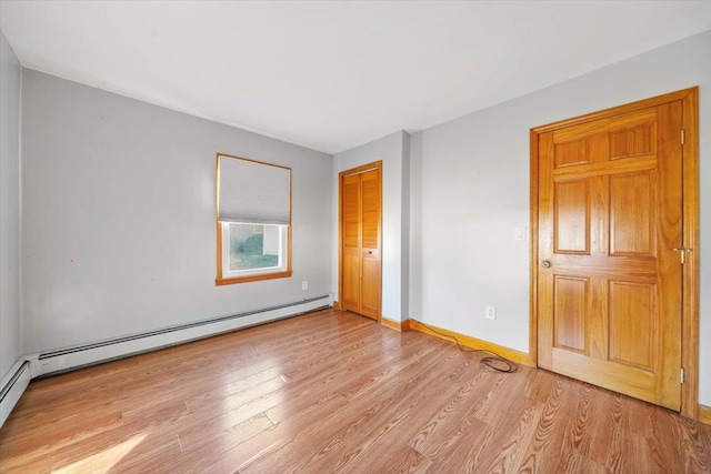 interior space featuring a baseboard radiator, a closet, and light hardwood / wood-style floors