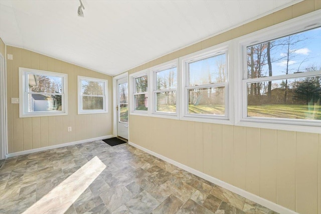 unfurnished sunroom featuring vaulted ceiling