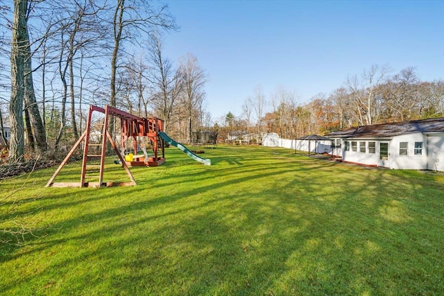 view of yard featuring a playground and a storage shed