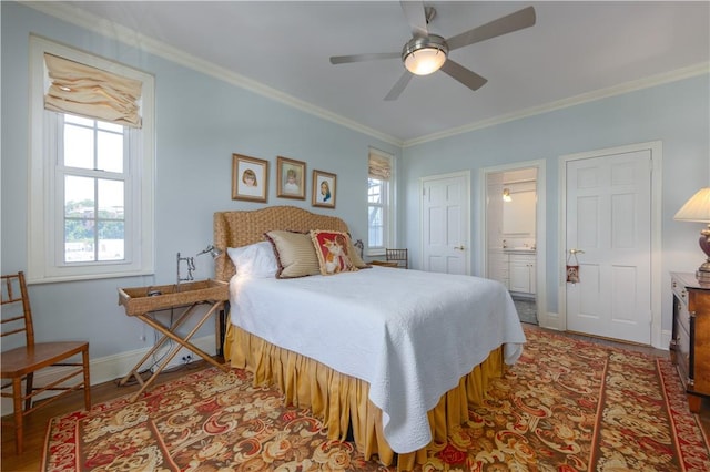 bedroom featuring ensuite bathroom, ceiling fan, and crown molding