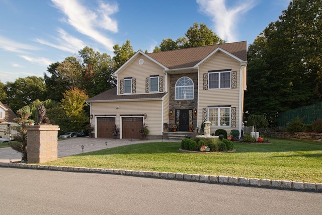 traditional home with stone siding, an attached garage, driveway, and a front lawn