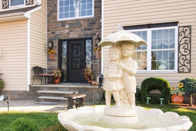 view of exterior entry featuring stone siding