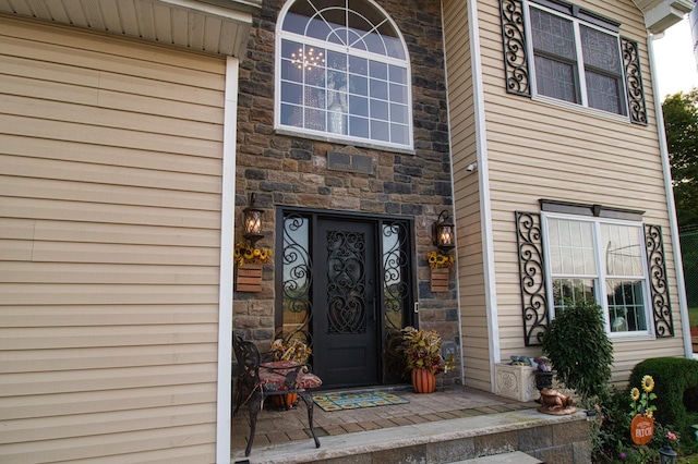 entrance to property featuring stone siding