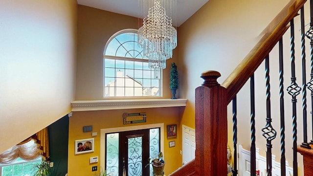 foyer entrance featuring a notable chandelier and stairs