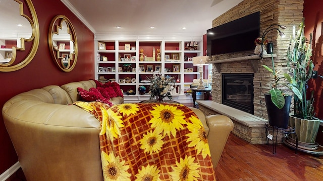 living area with a stone fireplace, recessed lighting, wood finished floors, and crown molding