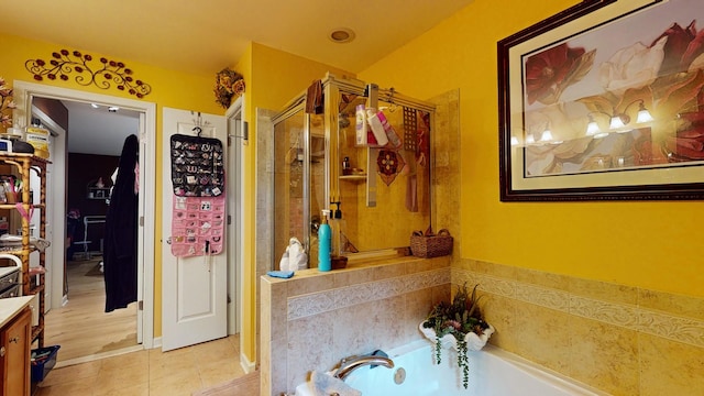 bathroom with a stall shower, tile patterned flooring, vanity, and a bath