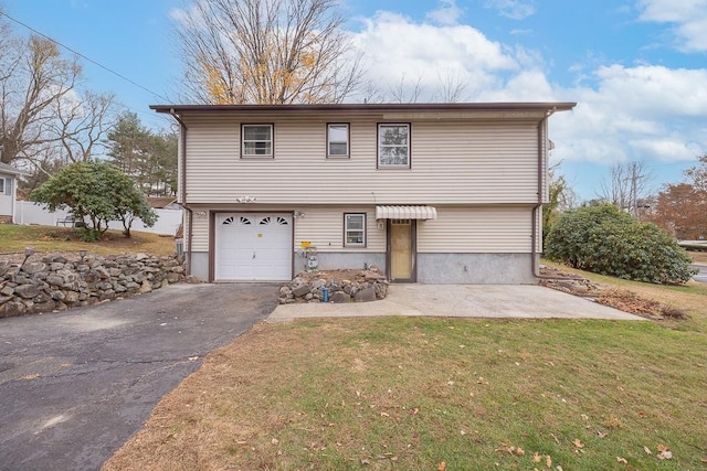 view of front of home featuring a garage and a front yard