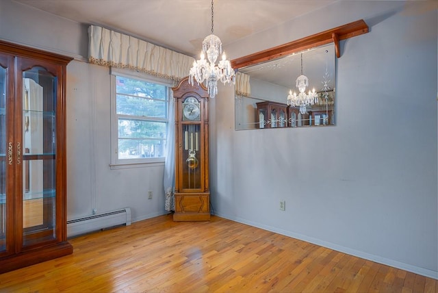 unfurnished dining area with beam ceiling, wood-type flooring, baseboard heating, and an inviting chandelier