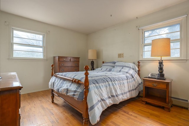 bedroom featuring multiple windows and light hardwood / wood-style floors