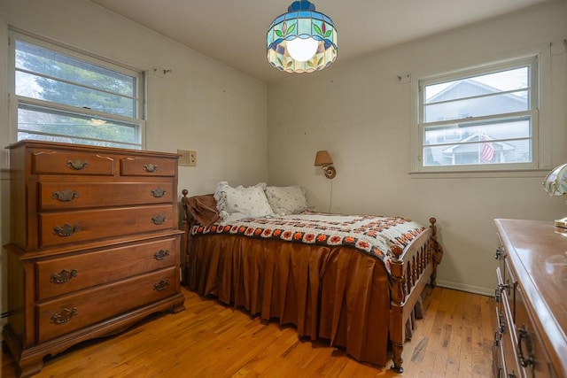 bedroom featuring light hardwood / wood-style floors and multiple windows