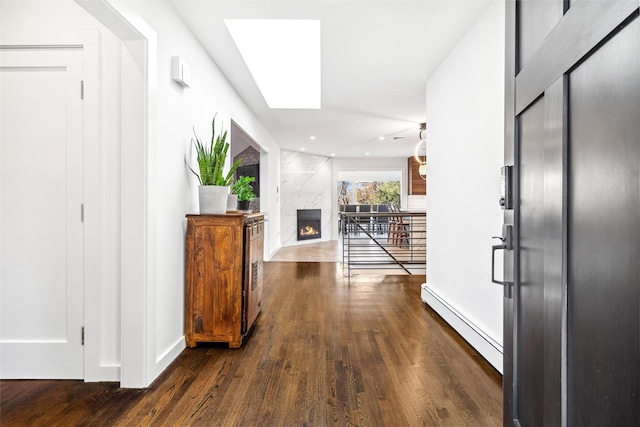 hallway featuring dark hardwood / wood-style flooring and a baseboard heating unit