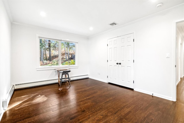 empty room with crown molding, dark hardwood / wood-style flooring, and baseboard heating