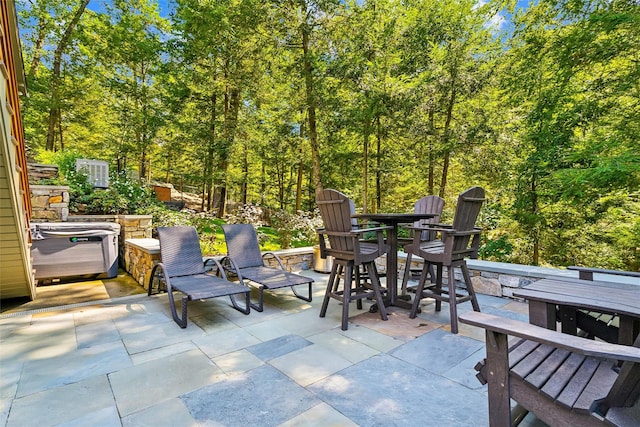 view of patio / terrace with a hot tub