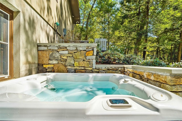 view of swimming pool featuring a hot tub