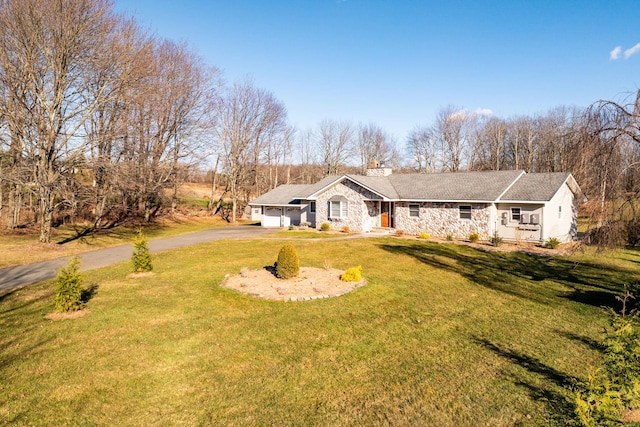 single story home featuring a front yard and a garage