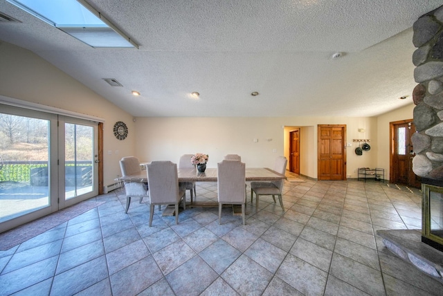 dining area with french doors, a textured ceiling, and lofted ceiling