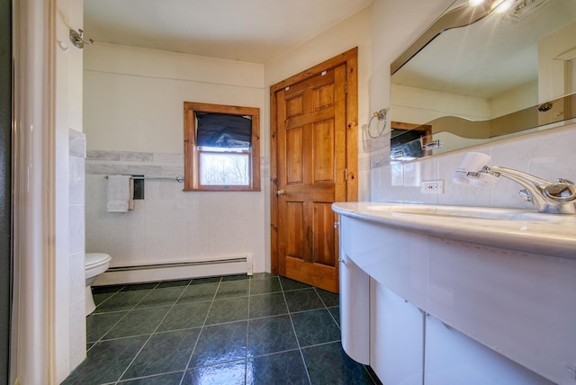 bathroom with tile patterned floors, vanity, a baseboard heating unit, tile walls, and toilet