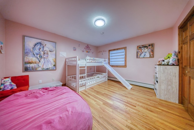 bedroom featuring light hardwood / wood-style flooring and baseboard heating