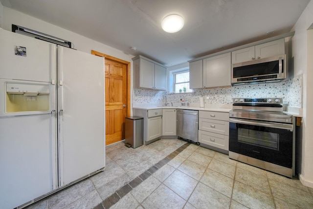 kitchen with decorative backsplash and appliances with stainless steel finishes