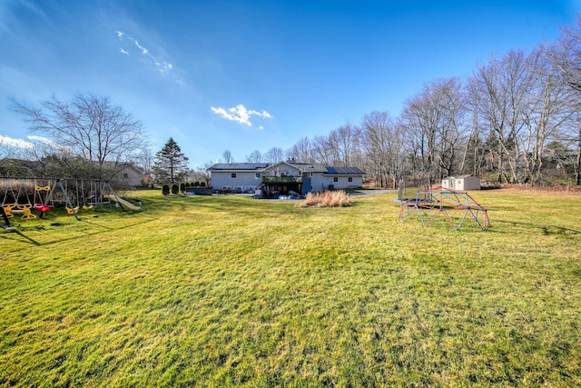 view of yard featuring a playground and a shed