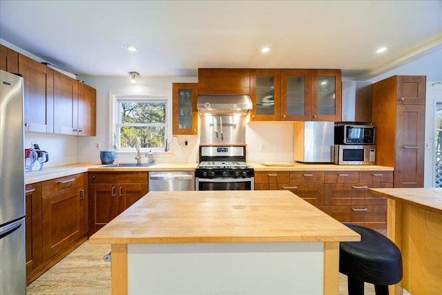 41 White Oaks Rd, Hyde Park, NY 12538 - kitchen featuring stainless steel appliances, wooden counters, wall chimney exhaust hood, a sink, and recessed lighting