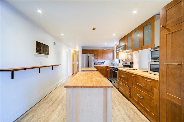 41 White Oaks Rd, Hyde Park, NY 12538 - kitchen with appliances with stainless steel finishes, butcher block countertops, light wood-style flooring, a kitchen island, and recessed lighting
