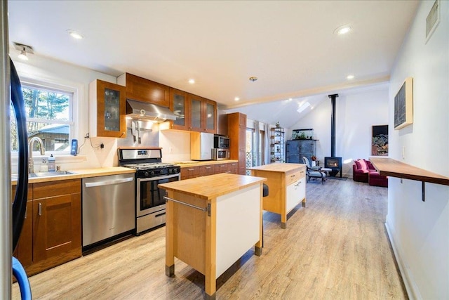 41 White Oaks Rd, Hyde Park, NY 12538 - kitchen with appliances with stainless steel finishes, wooden counters, a wood stove, light wood-style floors, and recessed lighting