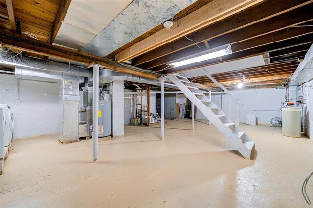 41 White Oaks Rd, Hyde Park, NY 12538 - unfinished below grade area with washing machine and dryer, stairs, a water softener, and water heater