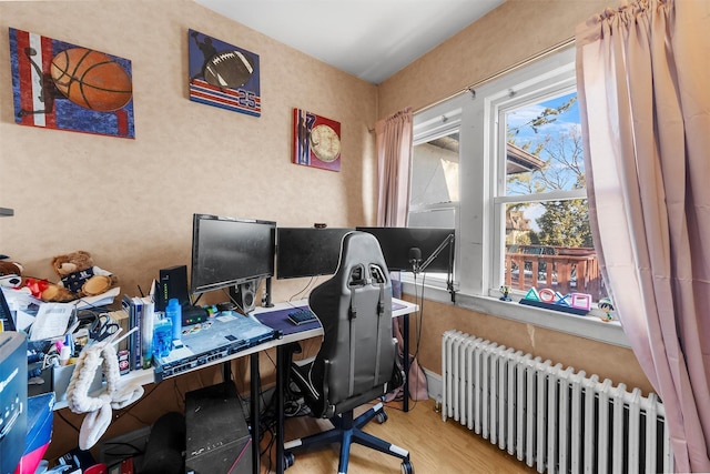 office with radiator and hardwood / wood-style floors