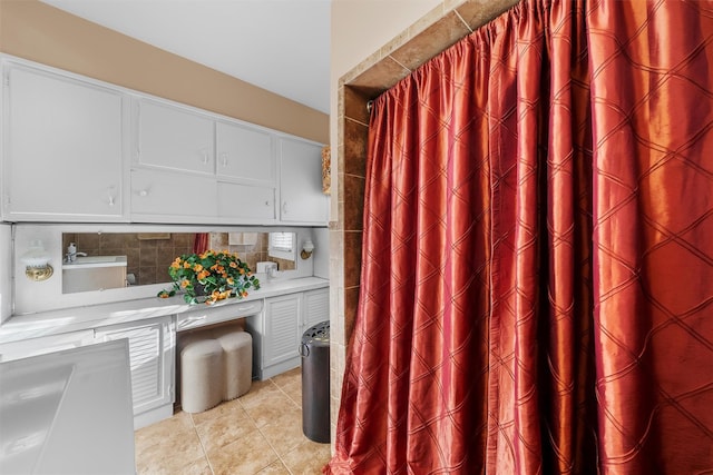 bathroom featuring tasteful backsplash and tile patterned flooring