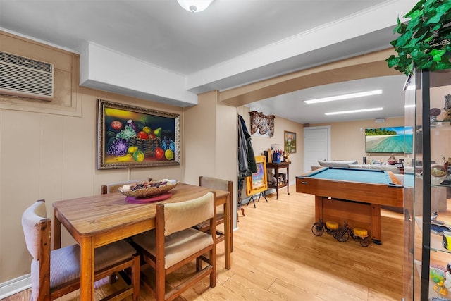 game room with billiards, light hardwood / wood-style floors, and an AC wall unit