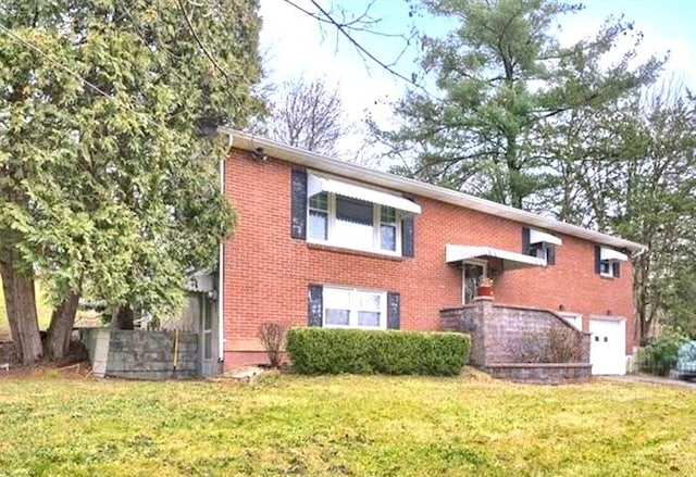 view of front of home with a front yard and a garage