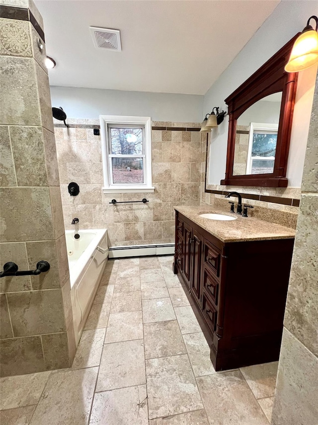 bathroom featuring vanity, tile walls, and a baseboard heating unit