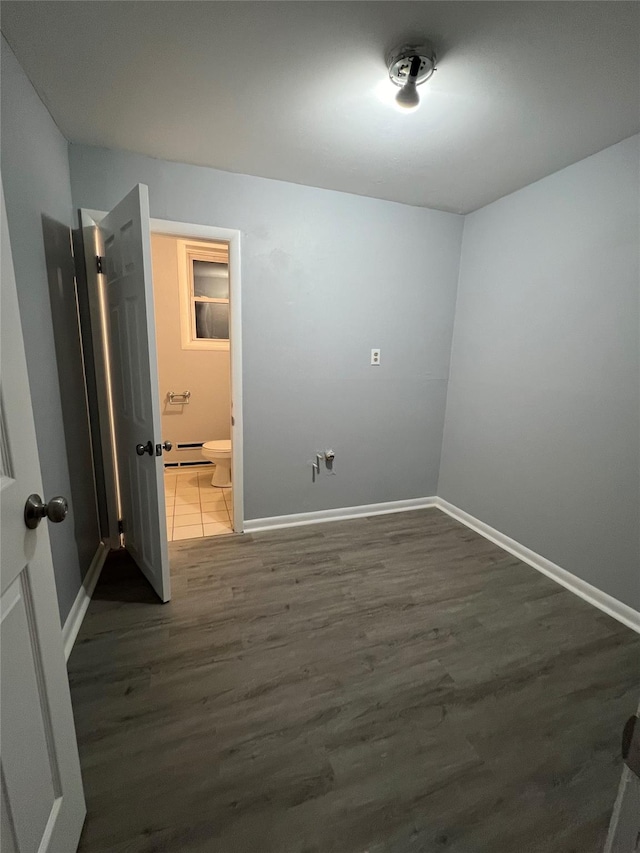 unfurnished room featuring dark hardwood / wood-style flooring