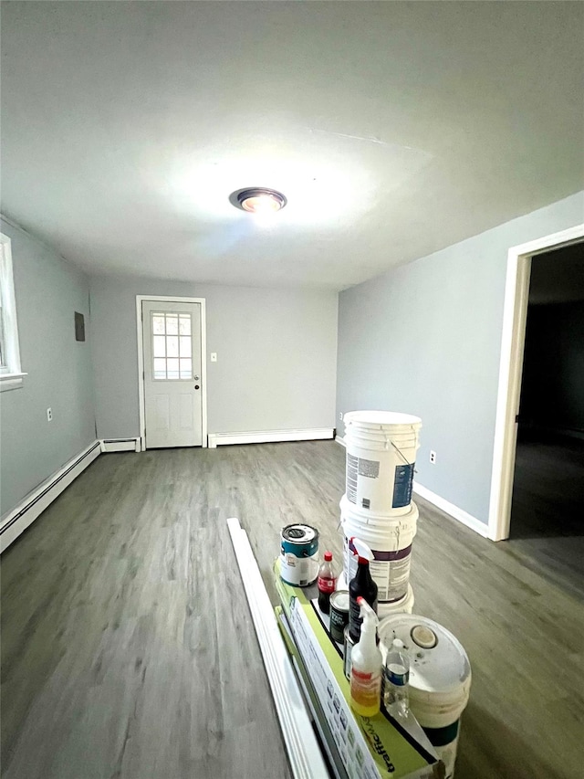 entrance foyer featuring baseboard heating and dark hardwood / wood-style floors