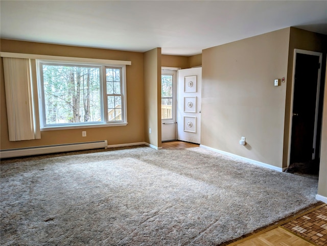 carpeted empty room with a baseboard heating unit