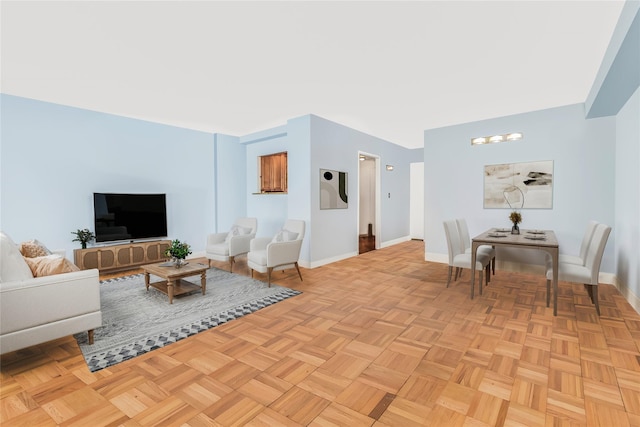 living room featuring a notable chandelier and light parquet flooring