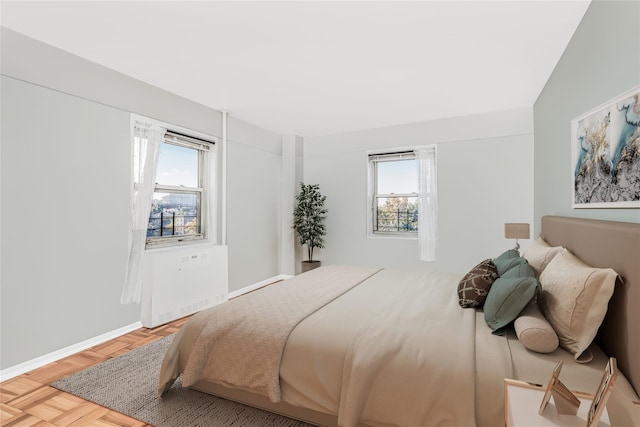 bedroom with parquet floors and lofted ceiling