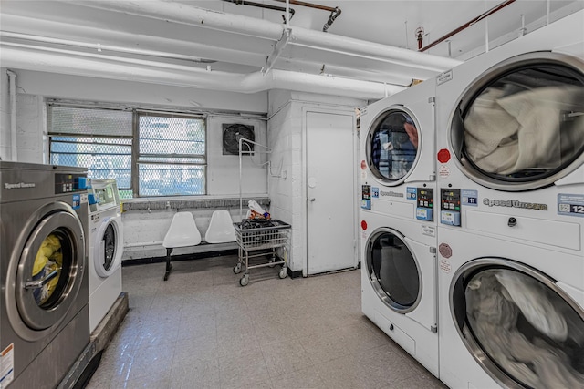 clothes washing area featuring stacked washer / dryer and separate washer and dryer
