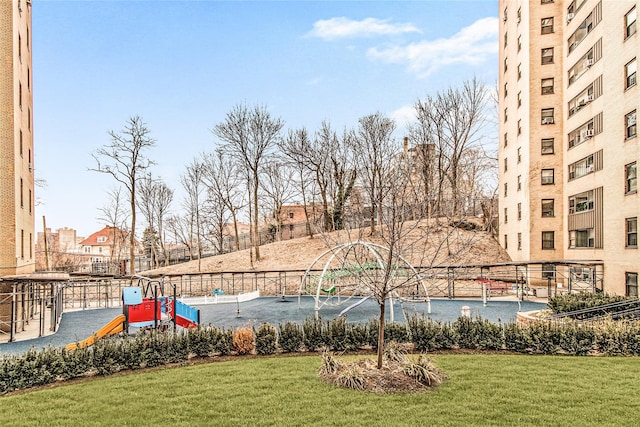 view of pool featuring a playground and a yard