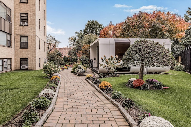 view of property's community with a lawn