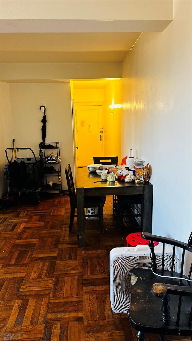 dining area featuring dark parquet flooring