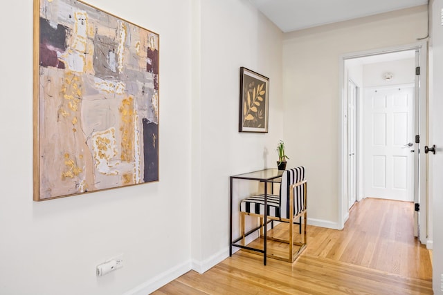 hall with hardwood / wood-style floors