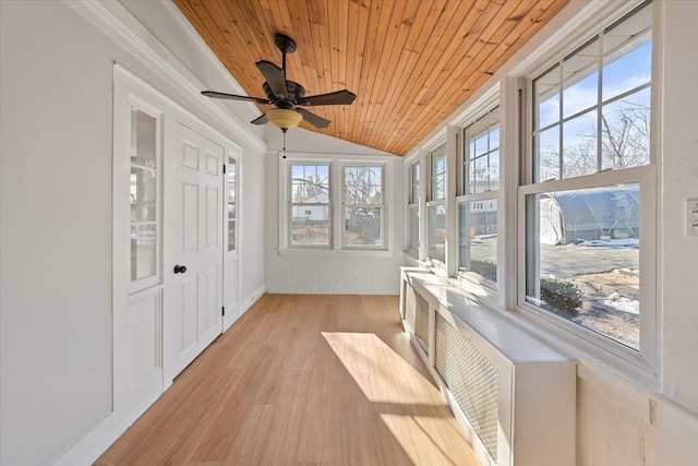 sunroom featuring lofted ceiling and wood ceiling