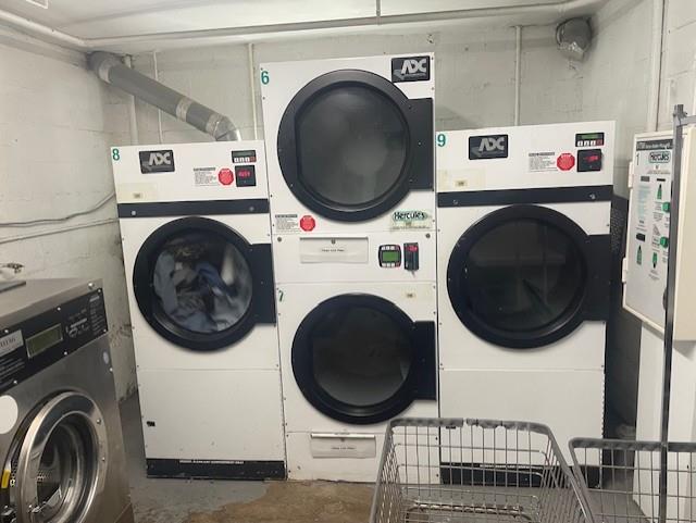 laundry room featuring stacked washer and clothes dryer and independent washer and dryer